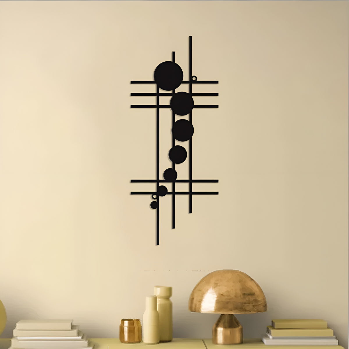 Black geometric iron wall decor with lines and circles mounted on a cream wall above a shelf