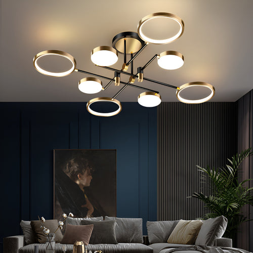 Modern black and gold 8-head LED ceiling chandelier with ring lights above a living room sofa