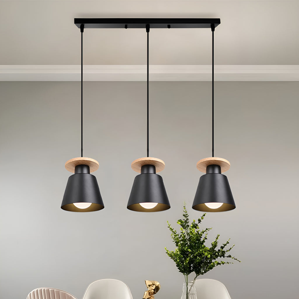 Black iron three-head long frame pendant light with wood accents above a dining table