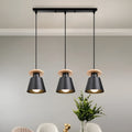 Black iron three-head long frame pendant light with wood accents above a dining table