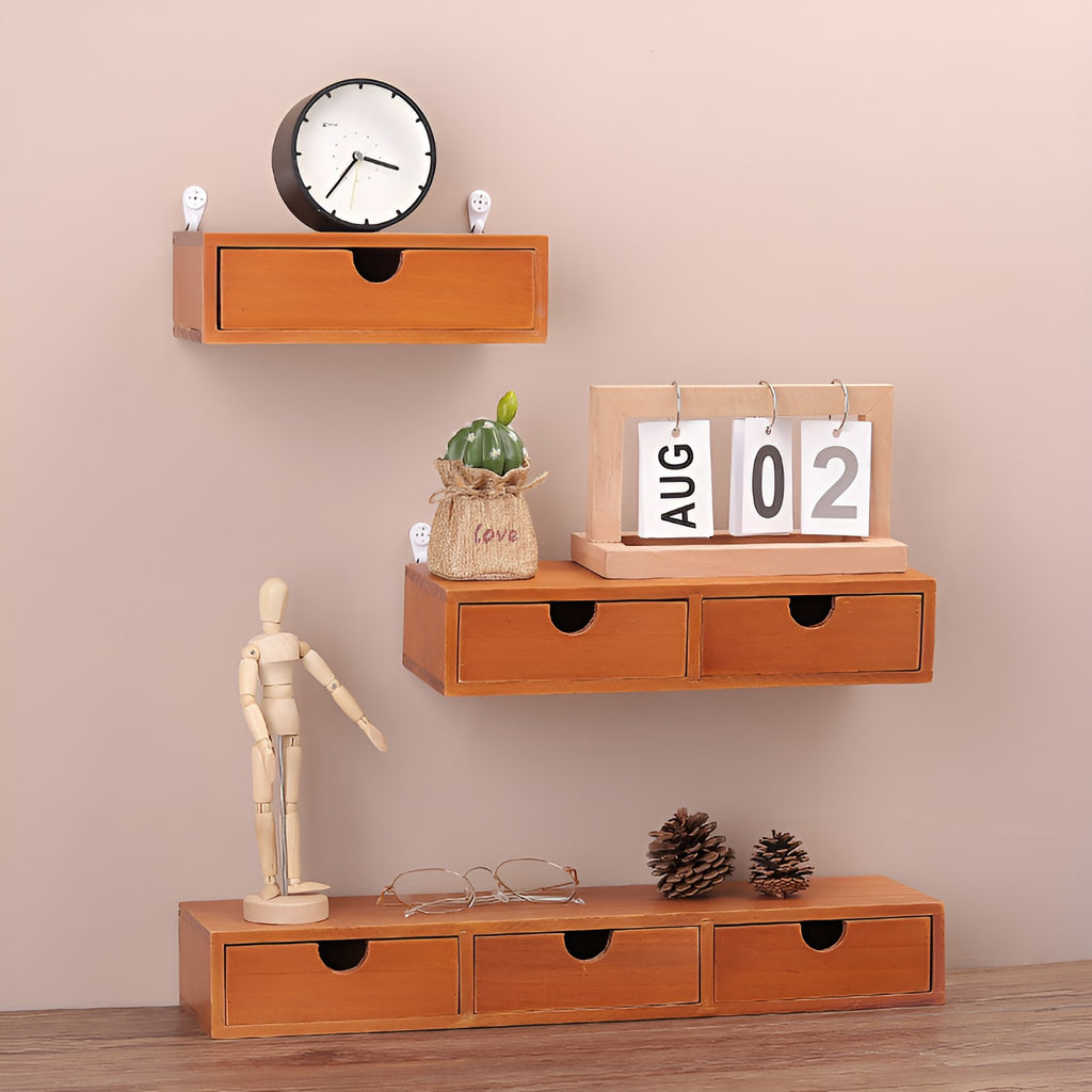 Retro wooden drawer boxes with one, two and three drawers displayed on a wall and tabletop